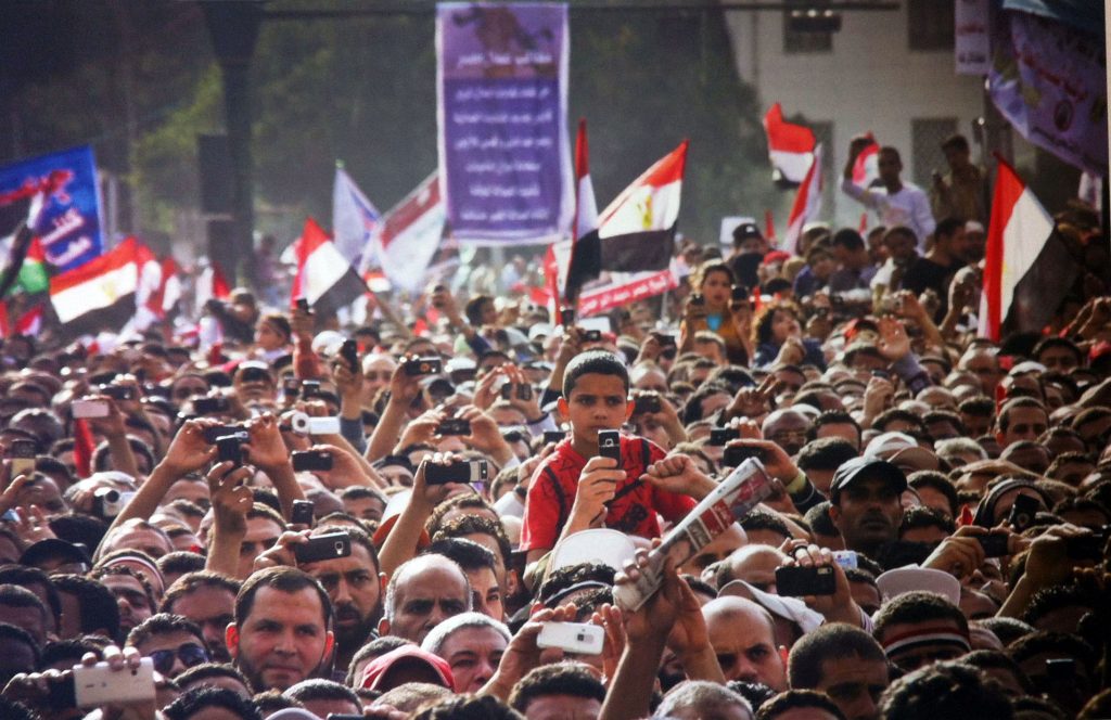 Image: Protesters during a speech in Tahrir Square, April 8, 2011. Photo by Mosa’ab Elshamy. © Mosa’ab Elshamy. Shared courtesy of Lara Baladi.