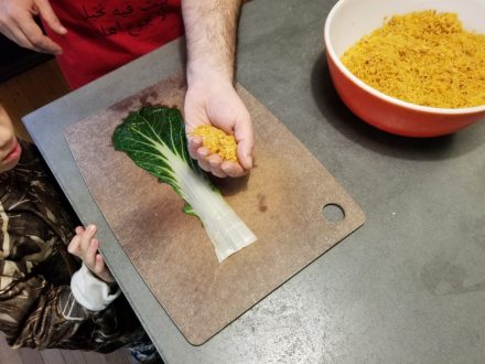 Michael Rakowitz and his son make Iraqi dolma, or mhasha, with bok choy. Photo courtesy of the artist.