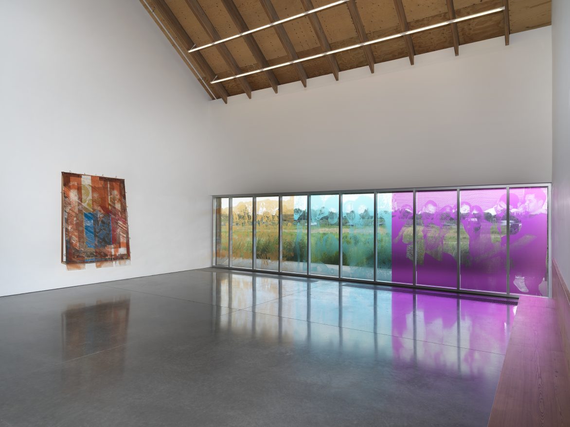 Tomashi Jackson: The Land Claim. Installation view: Parrish Art Museum, Water Mill, NY, July 11–November 7, 2021. Left to right:  The Three Sisters, 2021. Collaborative Work: Vessels of Light (From Jeremy, Juni, and Steven), 2021. Pigmented, archival ink on polycarbonate sheets. Window installation with photographs by Jeremy Dennis; Richard “Juni” Wingfield; and Juntos, New York, USA, 2020, by Steven Molina Contreras. Photo: Dario Lasagni 